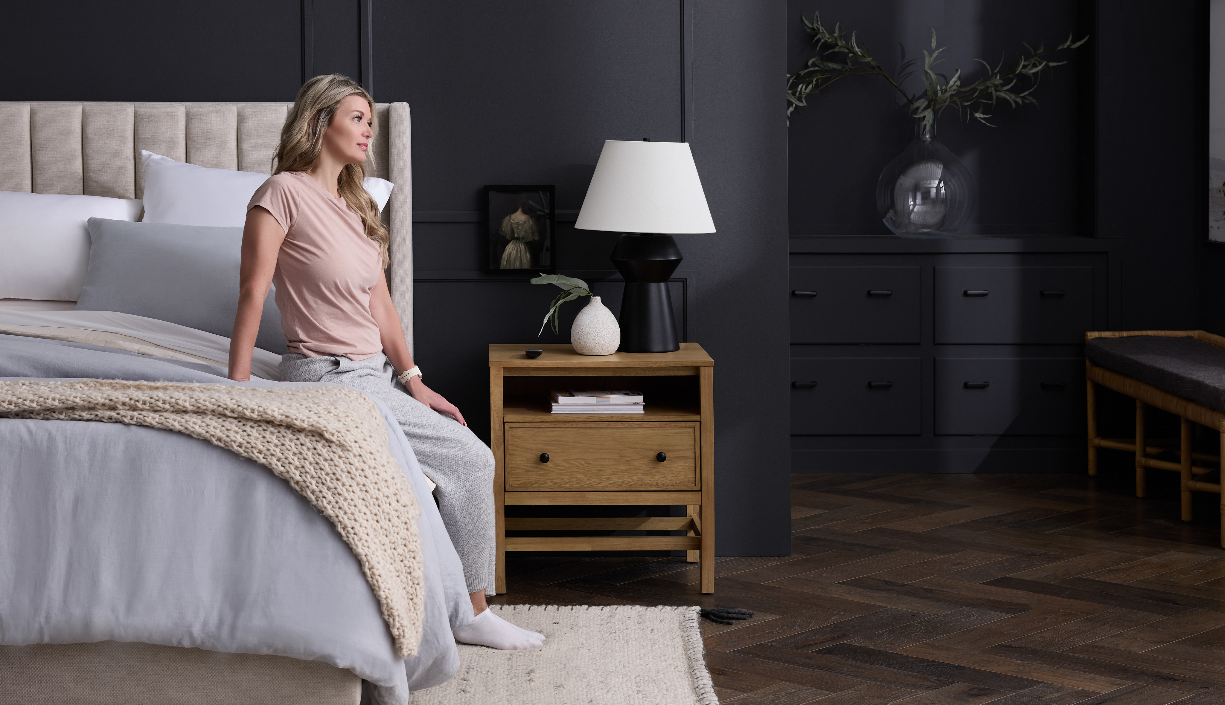 Person sitting on edge of the bed